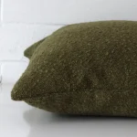 Side angle shot of linen square cushion cover. The olive green hue is shown.