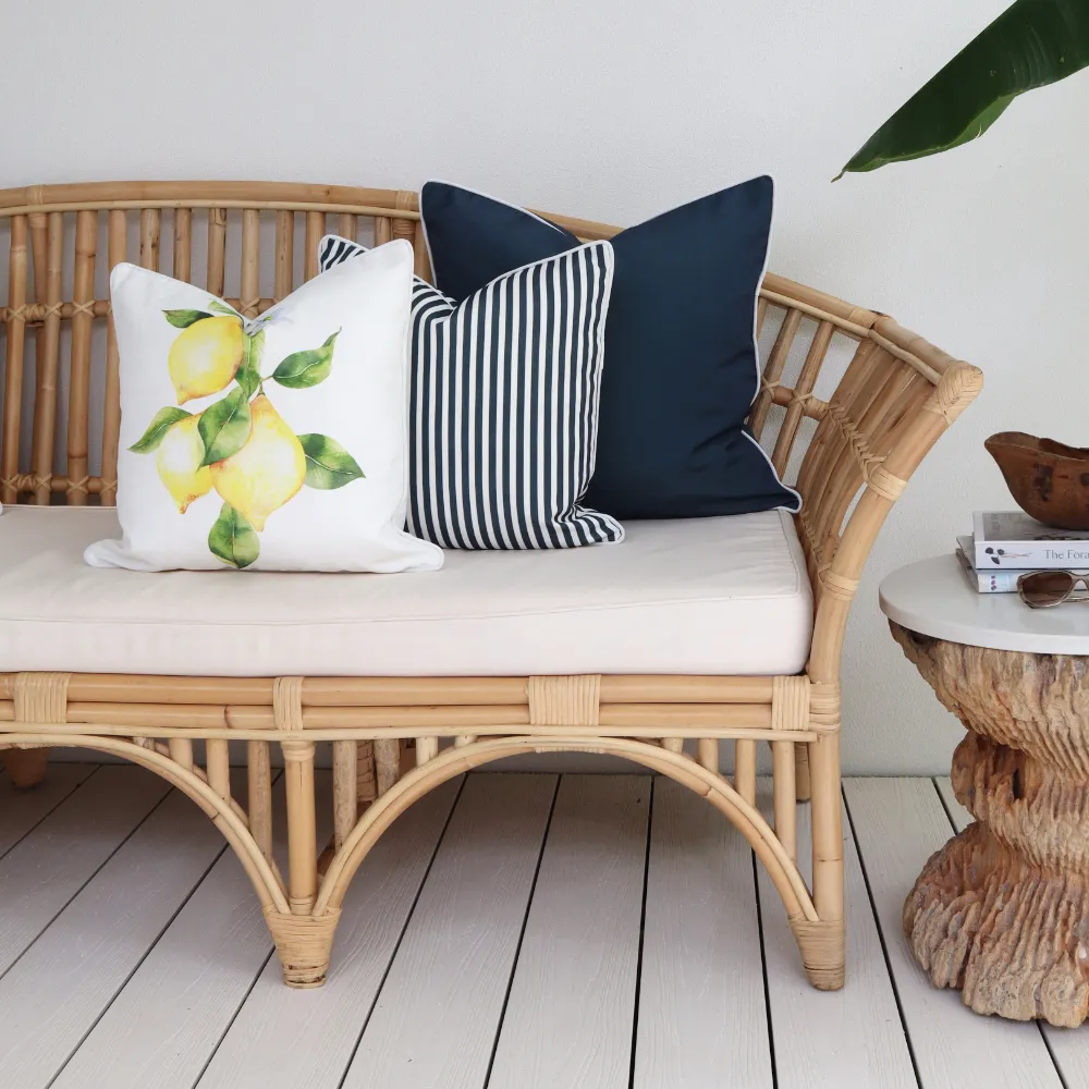 An outdoor cushion set placed on a rattan seat.