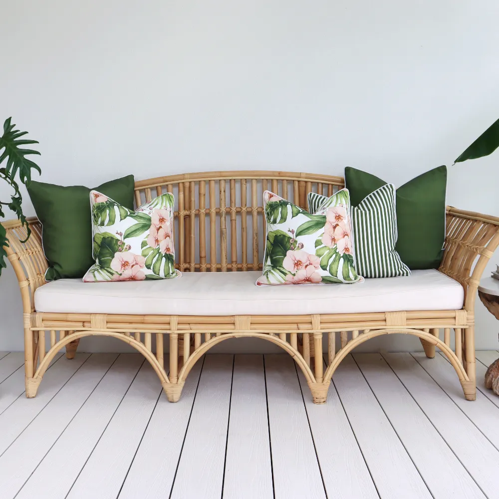 Five outdoor sofa cushions arranged on a seat out on a deck.