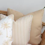 A close-up image of 3 beige outdoor couch cushions provides a thorough view of the colour hue and style.