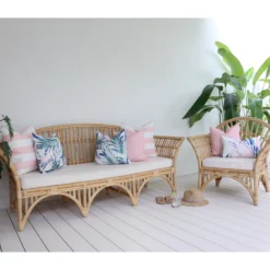 A perfect mix of pink outdoor cushions with palm prints adding charm to the lounge area.