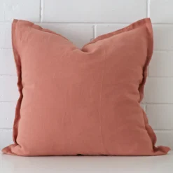 Gorgeous square linen cushion cover that has a pink hue.