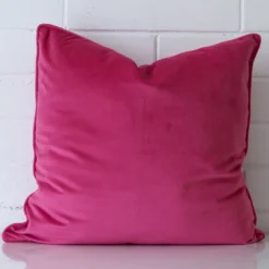 Gorgeous large velvet cushion cover that has a pink hue.