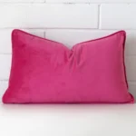 An eye-catching velvet rectangle cushion cover featuring a hue that is pink.