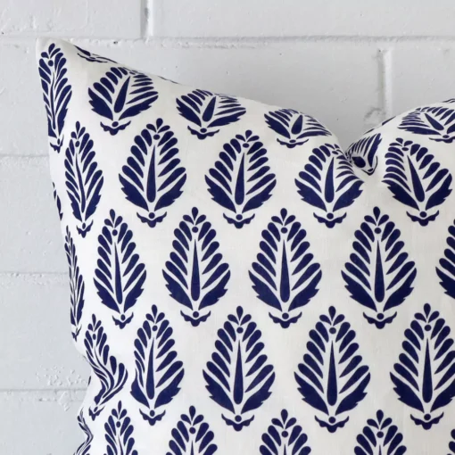 Macro shot showing the top left side of this square linen cushion. The blue hue and geometric design is magnified.