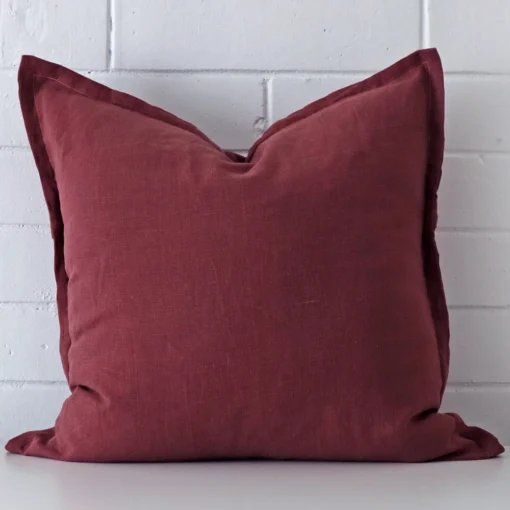 Front view of square cushion. Crafted from a special linen material in a plum colour.