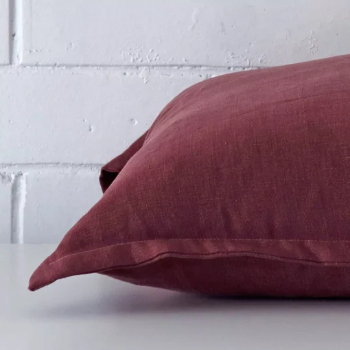 Lateral viewpoint of this linen square cushion. The plum colour is shown from the side showing the front and rear panels