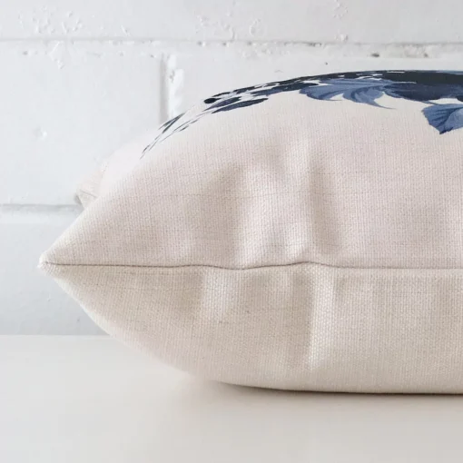 Square floral cushion sitting flat. The sideways viewpoint shows the seams of the linen material.