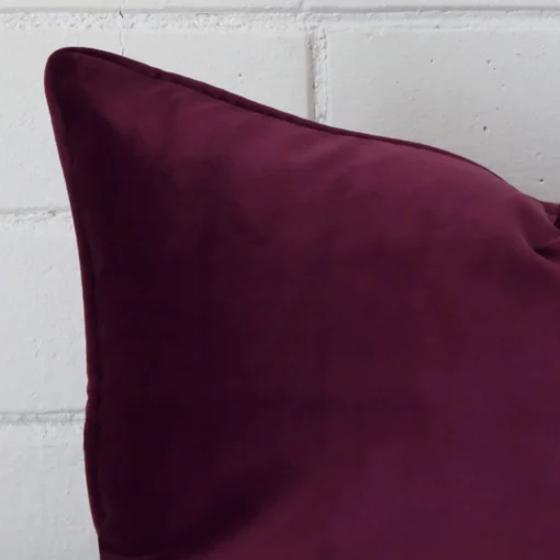 Very close photo of purple cushion. The shot shows the velvet material and rectangle dimensions with more clarity.