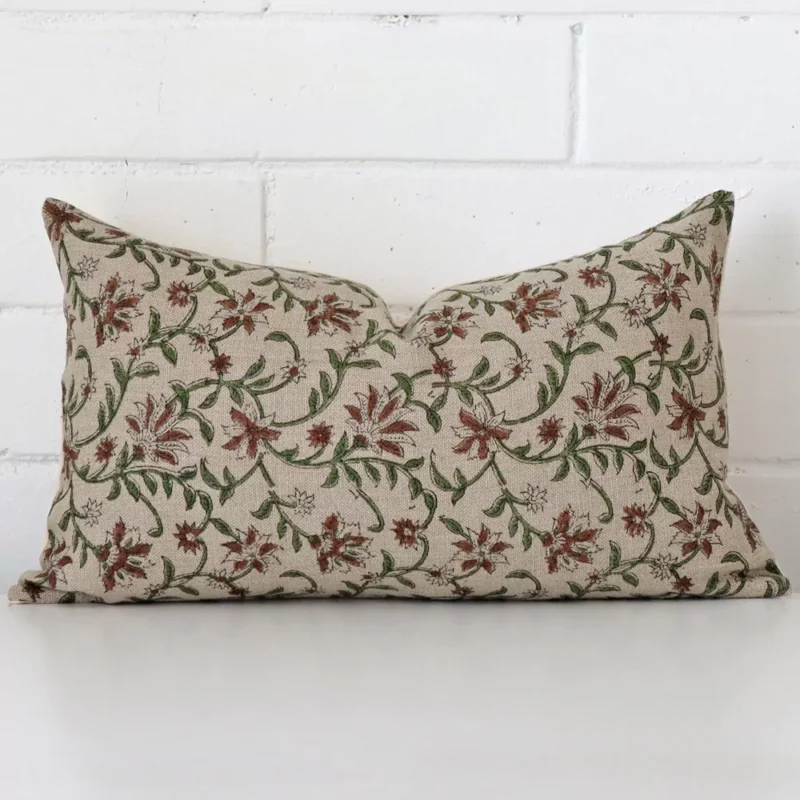raya-floral-designer-cushion-cover-rectangle-art124-30 Sesigner rectangle cushion with a floral design in an upright position against a white brick wall.