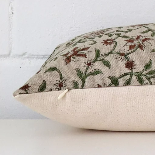 Rectangle cushion laid flat. This view shows the floral style and designer fabric from side on.
