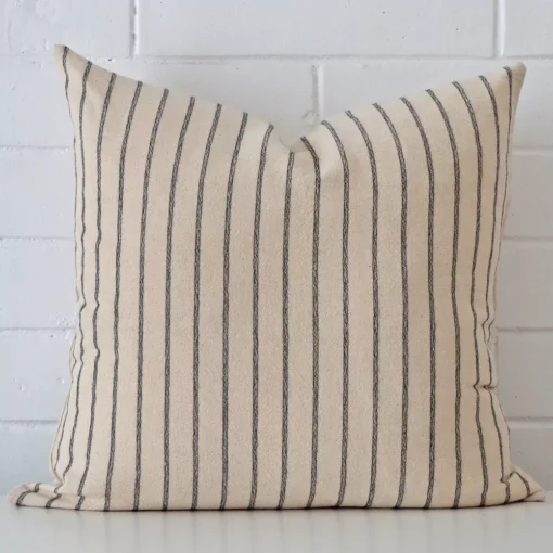A premium designer cushion boasting a striped design and in a square size.