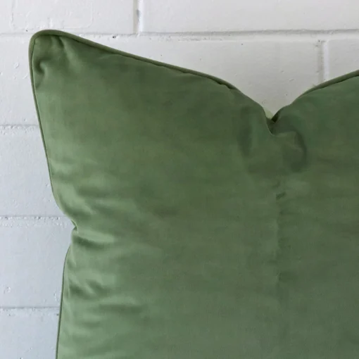 Very close photo of sage cushion. The shot shows the velvet material and large dimensions with more clarity.