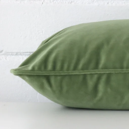 Rectangle velvet cushion cover positioned flat to show seams. The sage hue is shown more thoroughly.