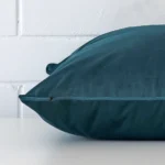 Large velvet cushion cover positioned flat to show seams. The teal hue is shown.