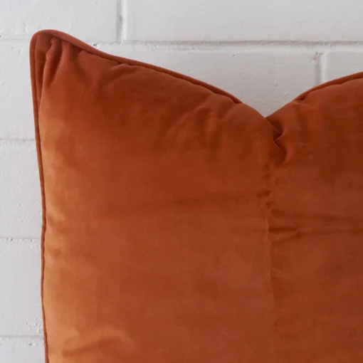 Precision shot of this large terracotta cushion cover. It is possible to see the velvet fabric in greater depth.