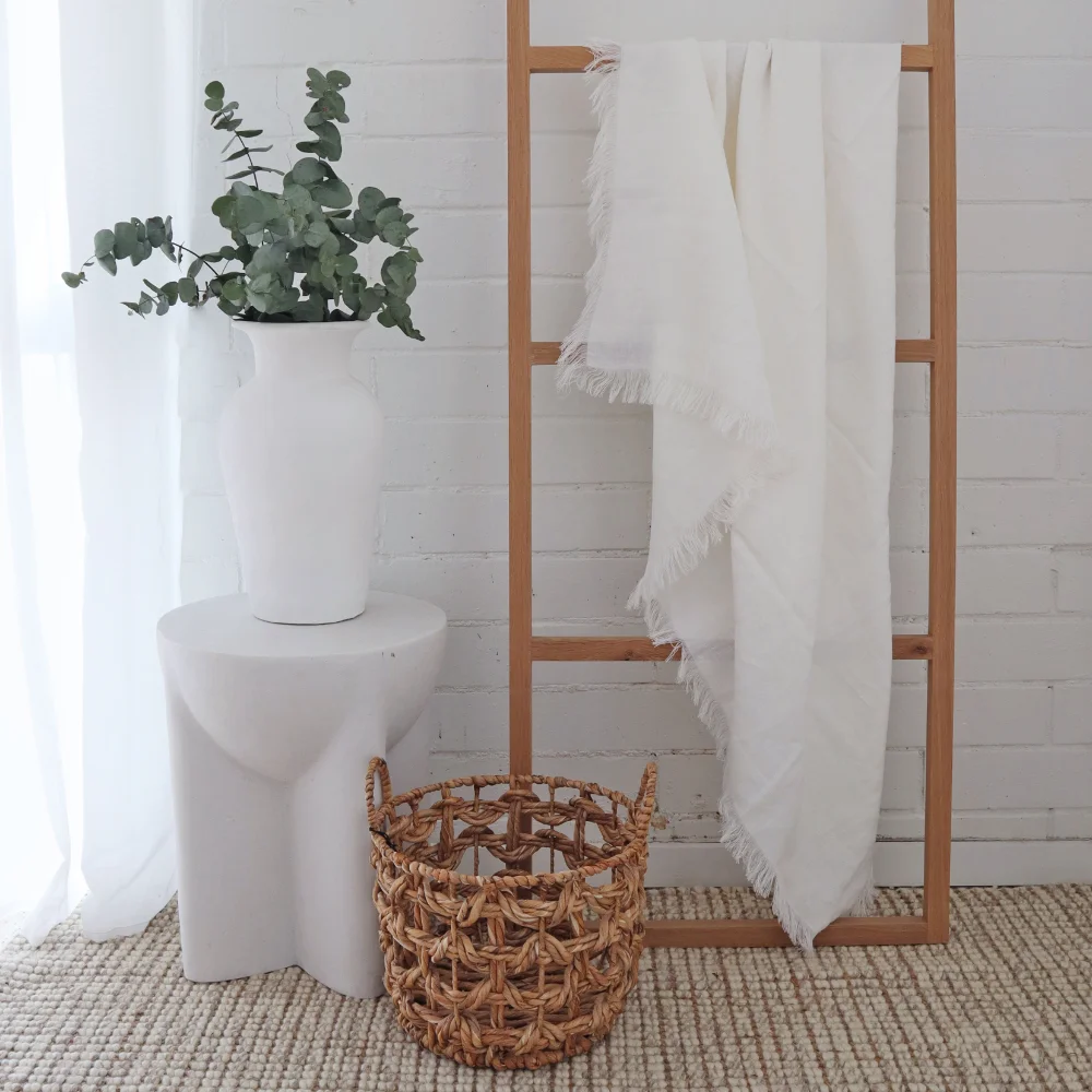 A throw blanket is hanging on a timber stand inside.