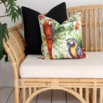 The elegance of tropical black outdoor cushions adorning a rattan sofa, offering both relaxation and sophistication.