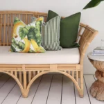 Three olive outdoor couch cushions including one with a banana design set the tropical vibe.