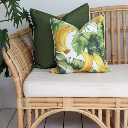 Tropical olive outdoor cushions on a rattan sofa.