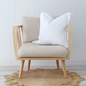 A white cushion on a modern chair that has a wooden frame.