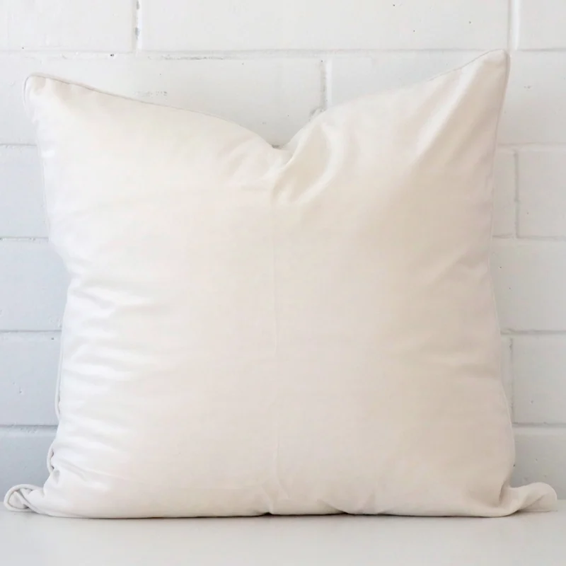 white-velvet-cushion-cover-55cm-x-55cm-sc761-55b White wall with a white cushion laying against it. It has a distinctive velvet fabric and has a large size.