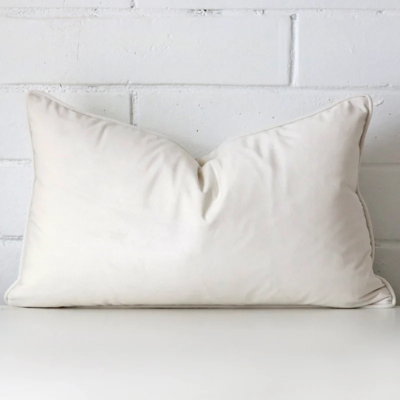 white-velvet-rectangular-cushion-cover-30cm-x-50cm-sc761-30 White velvet cushion cover features prominently against a white wall. It is a rectangle design.