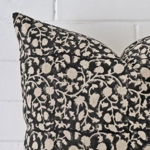 Magnified view of this designer cushion cover’s corner showing a floral design and its square size.