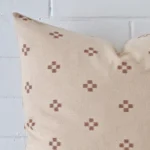 Close up view showing a corner of this designer cushion in a square size.