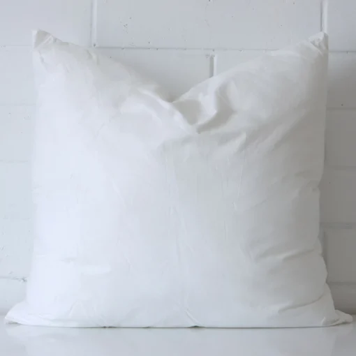 45x45 cushion insert with faux feather microfibre filling positioned against a white wall. The insert is sized at 45 x 45 cm.