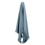 An attractive blue linen throw hanging down.