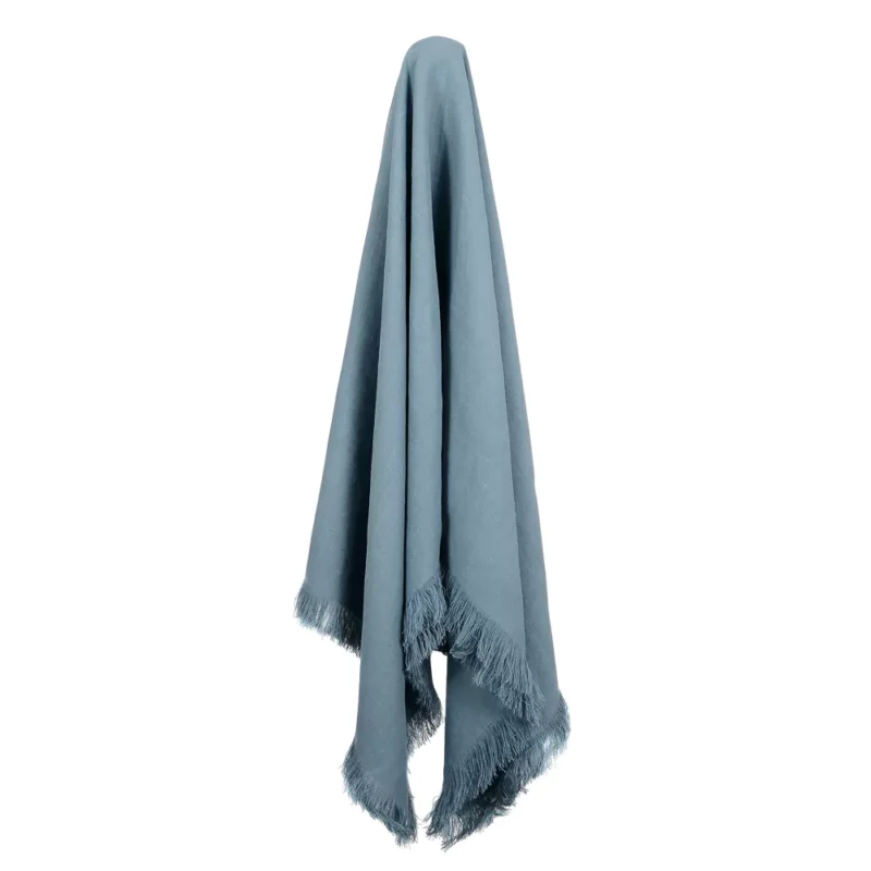 An attractive blue linen throw hanging down.