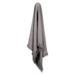 A beautiful grey-coloured linen throw hanging down.