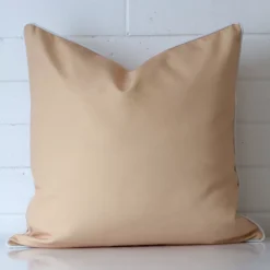 A premium outdoor beige cushion in a large size.