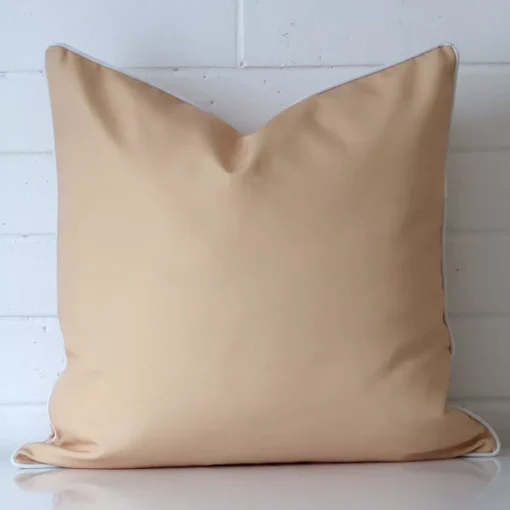 A premium outdoor beige cushion in a large size.