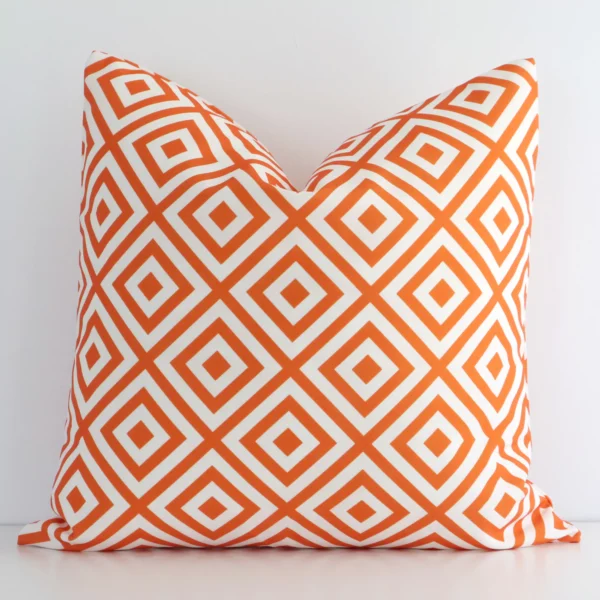 Gorgeous square outdoor cushion cover that has a orange hue. It has a graceful geometric design.