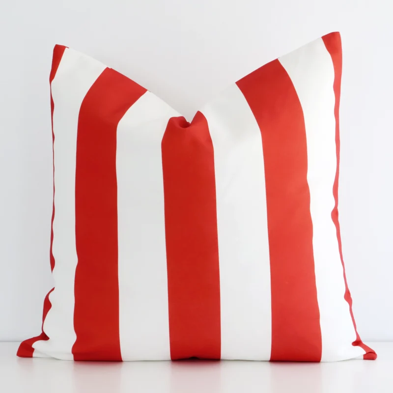 byron-striped-waterproof-red-large-outdoor-cushion-cover--large---sc721-55 A white wall that has a striped red cushion cover positioned in front of it. It has an exquisite outdoor material and a lovely large size.