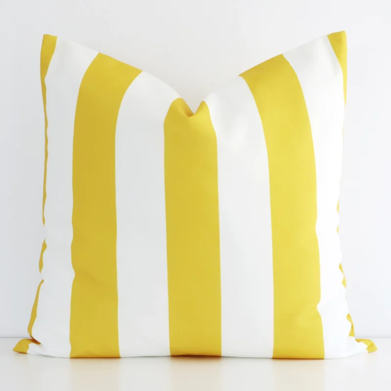 byron-striped-waterproof-yellow-large-outdoor-cushion-cover--large---sc729-55 An outdoor large cushion cover that has a unique striped design is shown vertically against a white wall. It has a wonderful yellow colour.