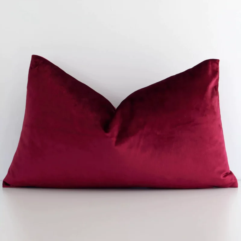 burgundy-velvet-rectangular-cushion-cover---rectangle---sc781-30 A hero shot of a solid-coloured rectangle cushion cover. It is made from a deluxe velvet fabric and features a burgundy colour.