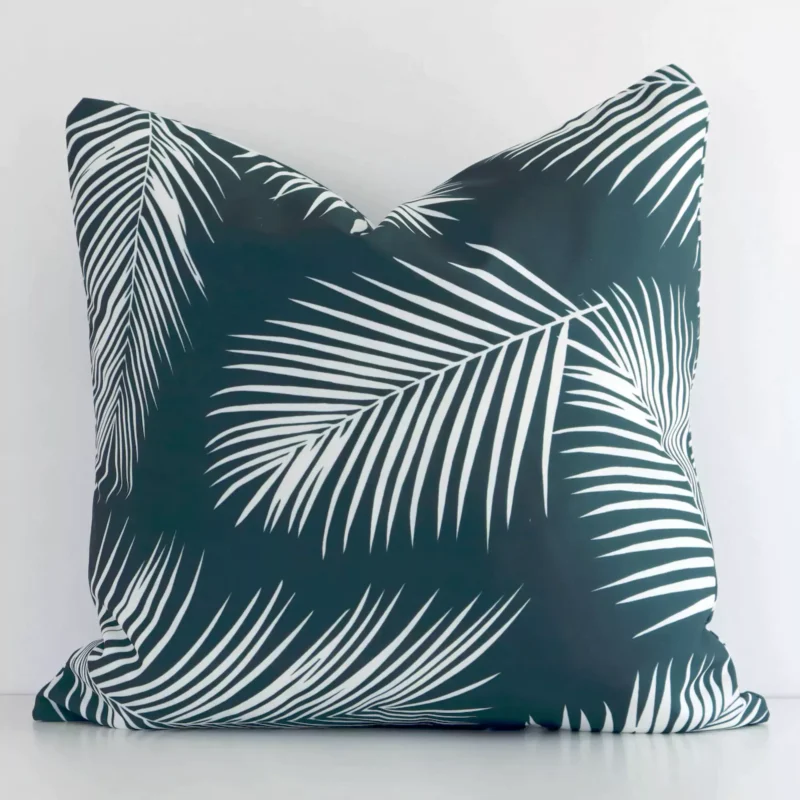 byron-palm-waterproof-green-outdoor-cushion-cover-SC950-45 Bold square green cushion positioned in front of a white wall. Its palm style pops on the outdoor fabric.
