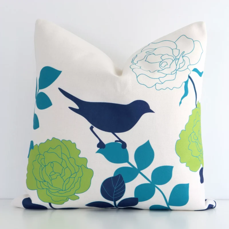 dendy-finch-cushion-cover---45cm-x-45cm---sc178-45 A square floral cushion in a delightful colourful tone rests against a white wall. The linen material appears to be of exceptional quality.
