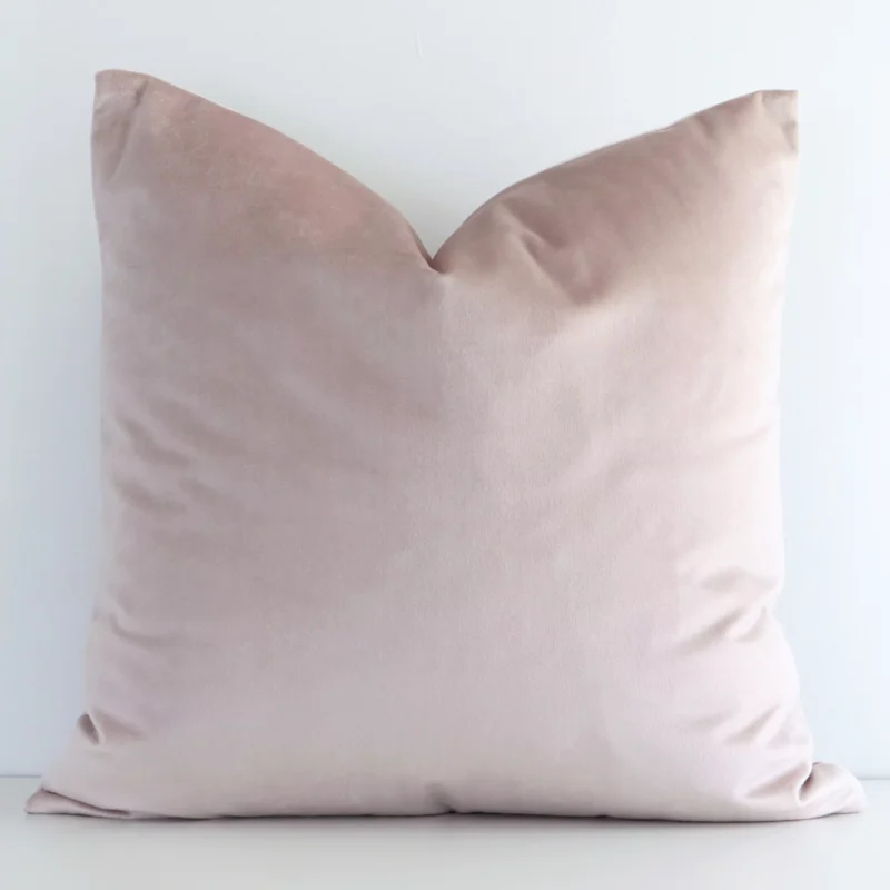 dusty-pink-velvet-linen-cushion-cover---sc508-45 A lovely square dusty pink cushion cover arranged in front of a white wall. The solid-coloured style complements the velvet material.