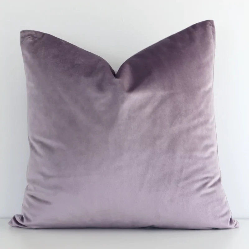 lavender-velvet-linen-cushion-cover---sc511-45 A velvet square cushion cover that has a solid colour design is shown vertically against a white wall. It has a wonderful lavender colour.