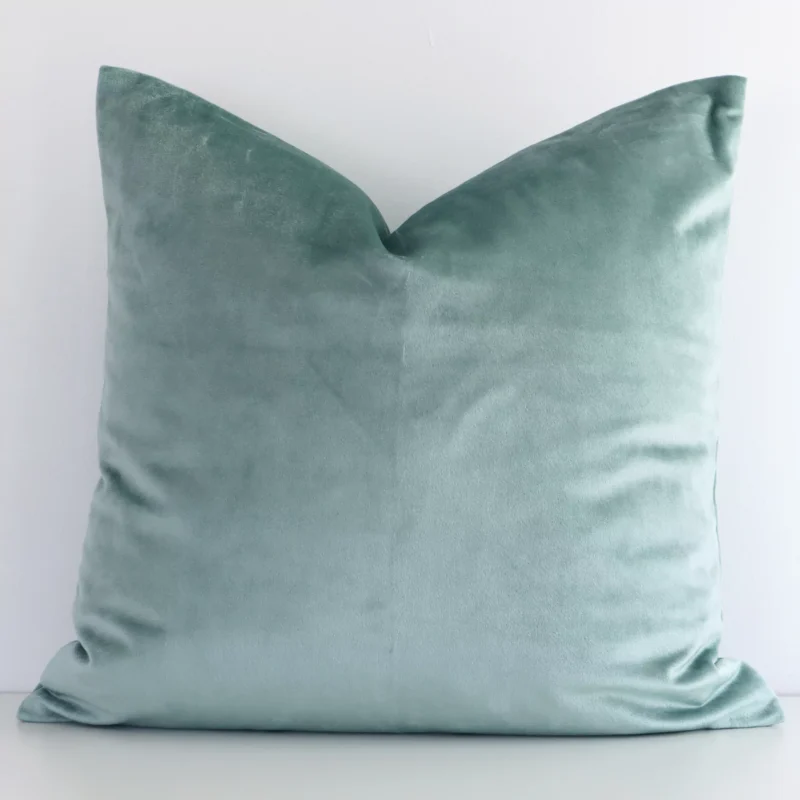 mint-green-velvet-linen-cushion-cover---sc506-45 Here a mint green velvet cushion is shown styled against a white wall. It has a square design.