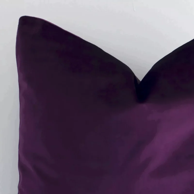 Very close photo of plum purple cushion. The shot shows the velvet material and square shape with more clarity.