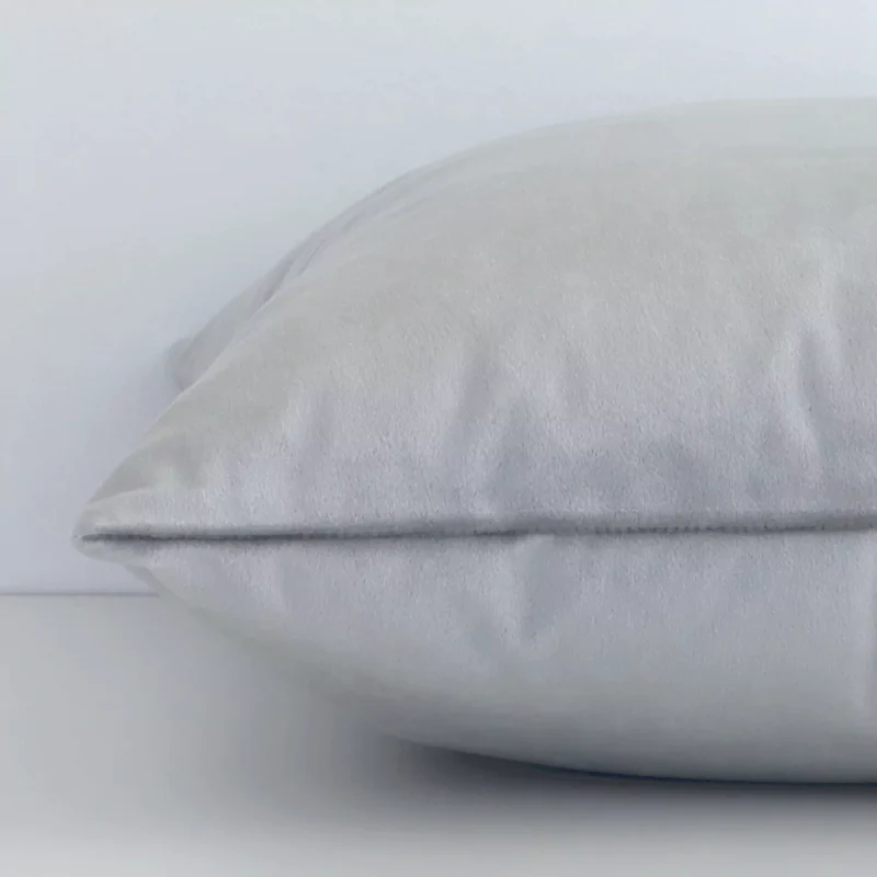 Square velvet cushion cover positioned flat to show seams. The silver hue and solid-coloured design are shown between front and rear fabric panels.
