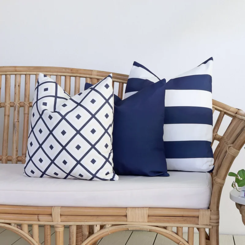 Byron Navy Outdoor Couch Cushions Set - 3 Covers A set of 3 Byron navy outdoor cushions are displayed on a rattan seat.