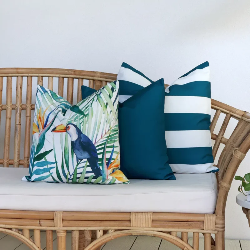 Byron Toucan Outdoor Couch Cushions Set - 3 Covers Outdoor living area with a rattan seat that is showcasing a set of 3 Byron toucan couch cushions.