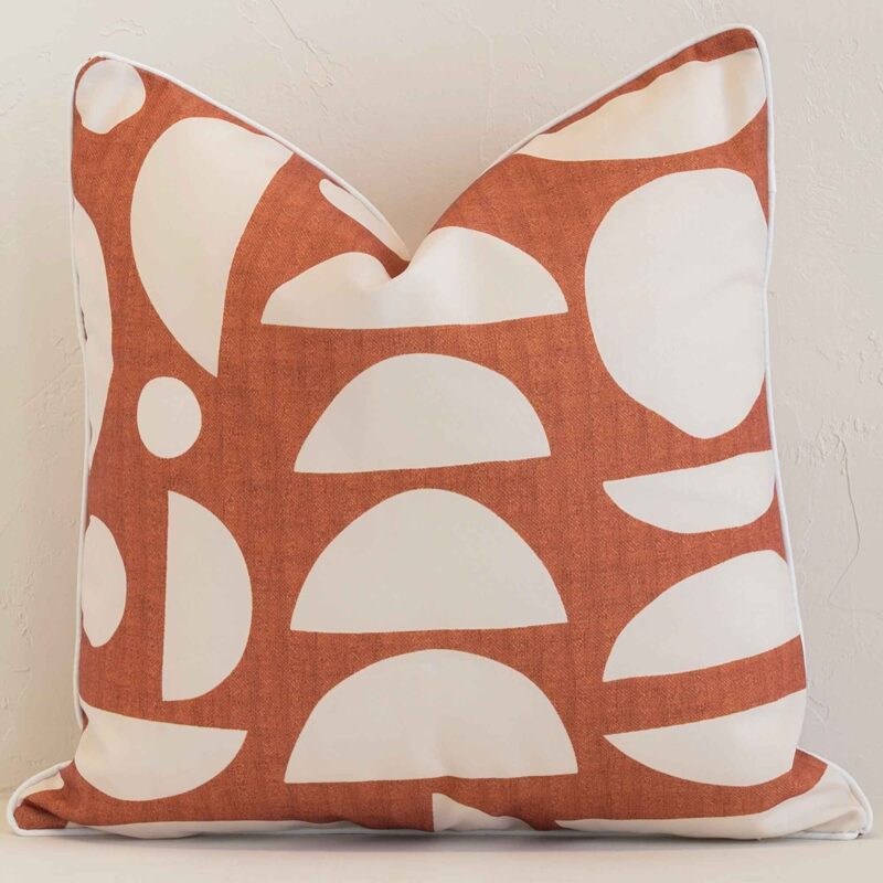 Precision shot of this square rust cushion cover. It is possible to see the geometric style and outdoor fabric in greater depth.
