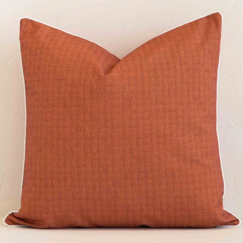 Vibrant solid-coloured rust cushion cover constructed from outdoor fabric and shown in a large size.